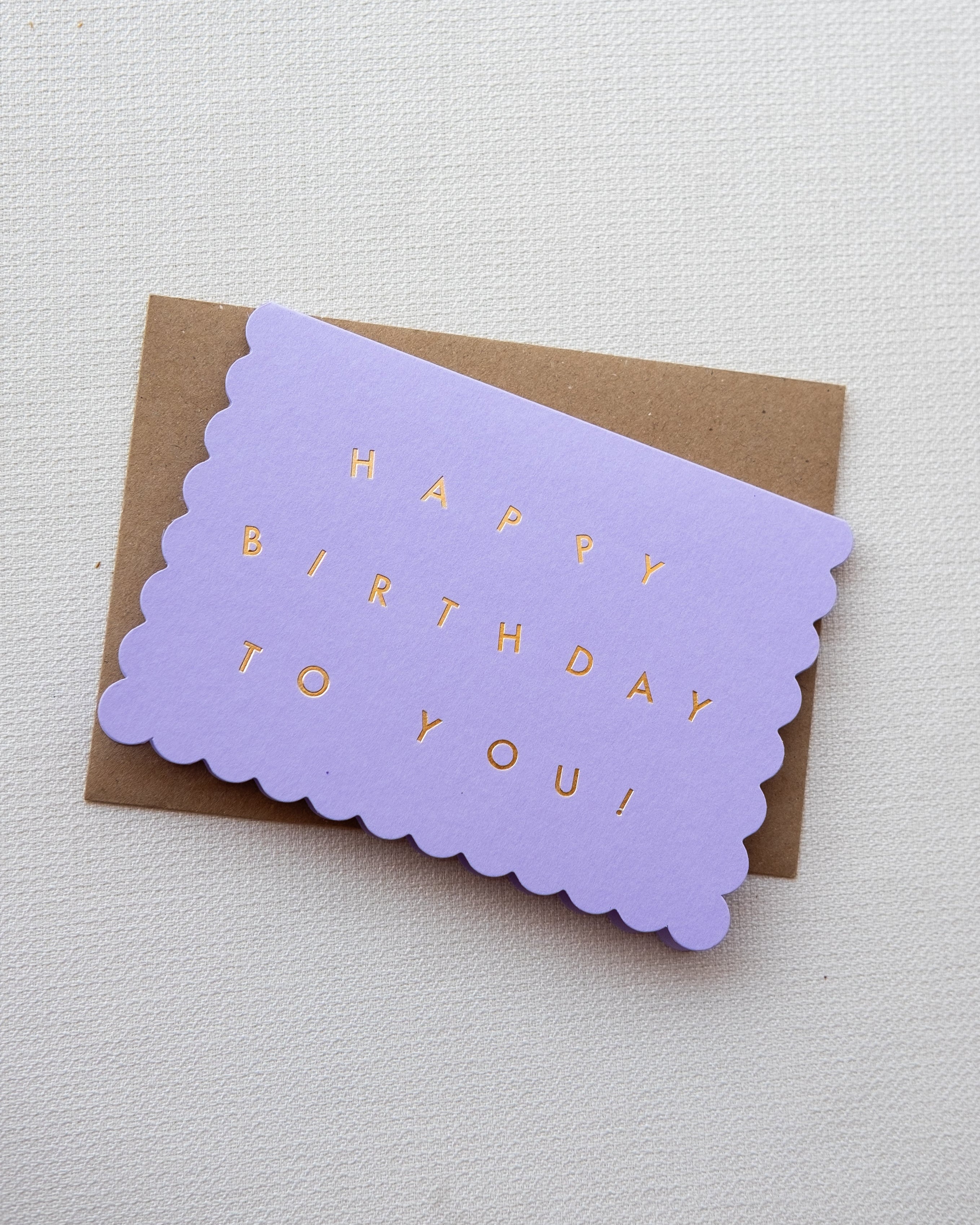 Lavender birthday card with scalloped edge on a white background