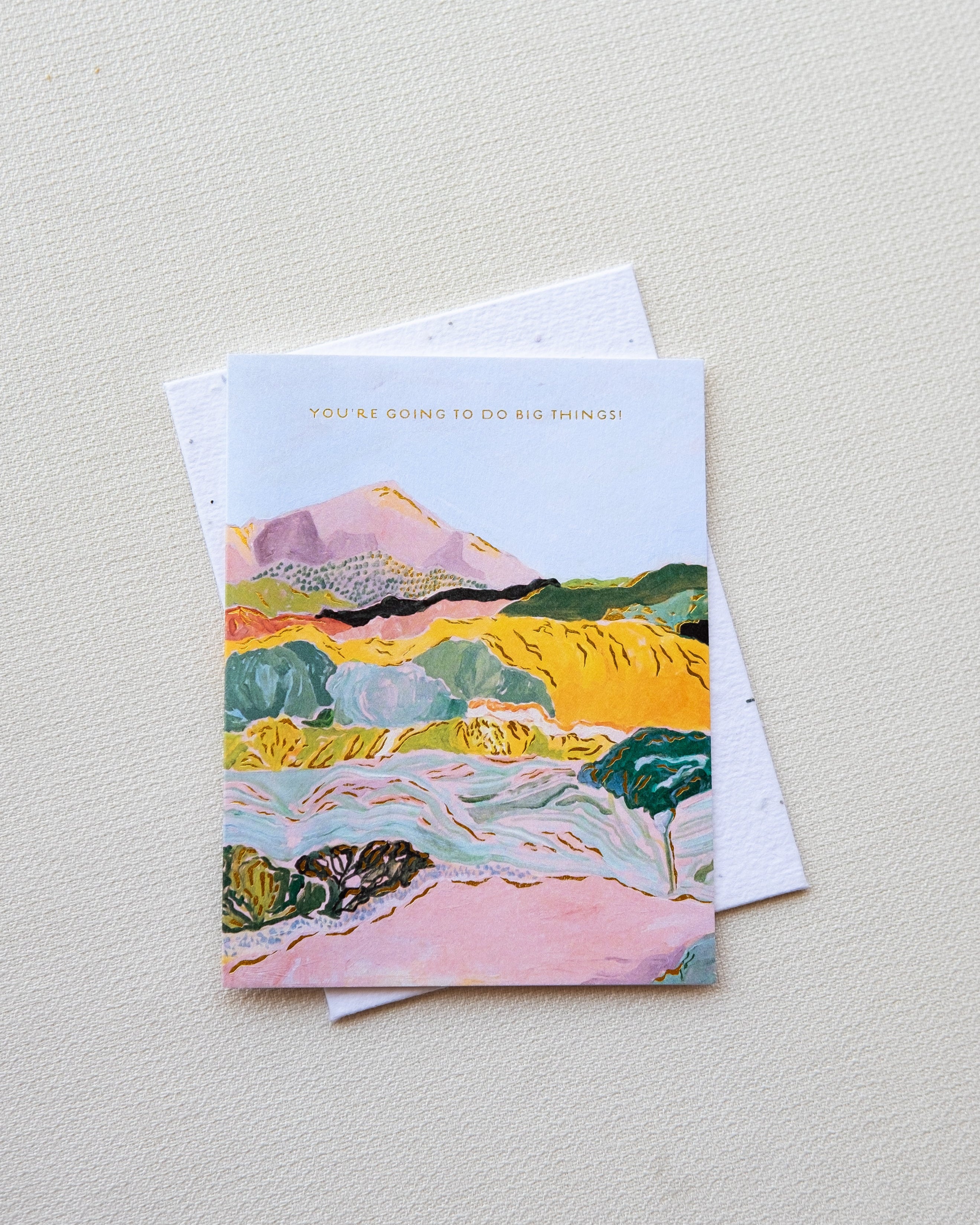 Greeting card with colorful landscape design on a light gray background