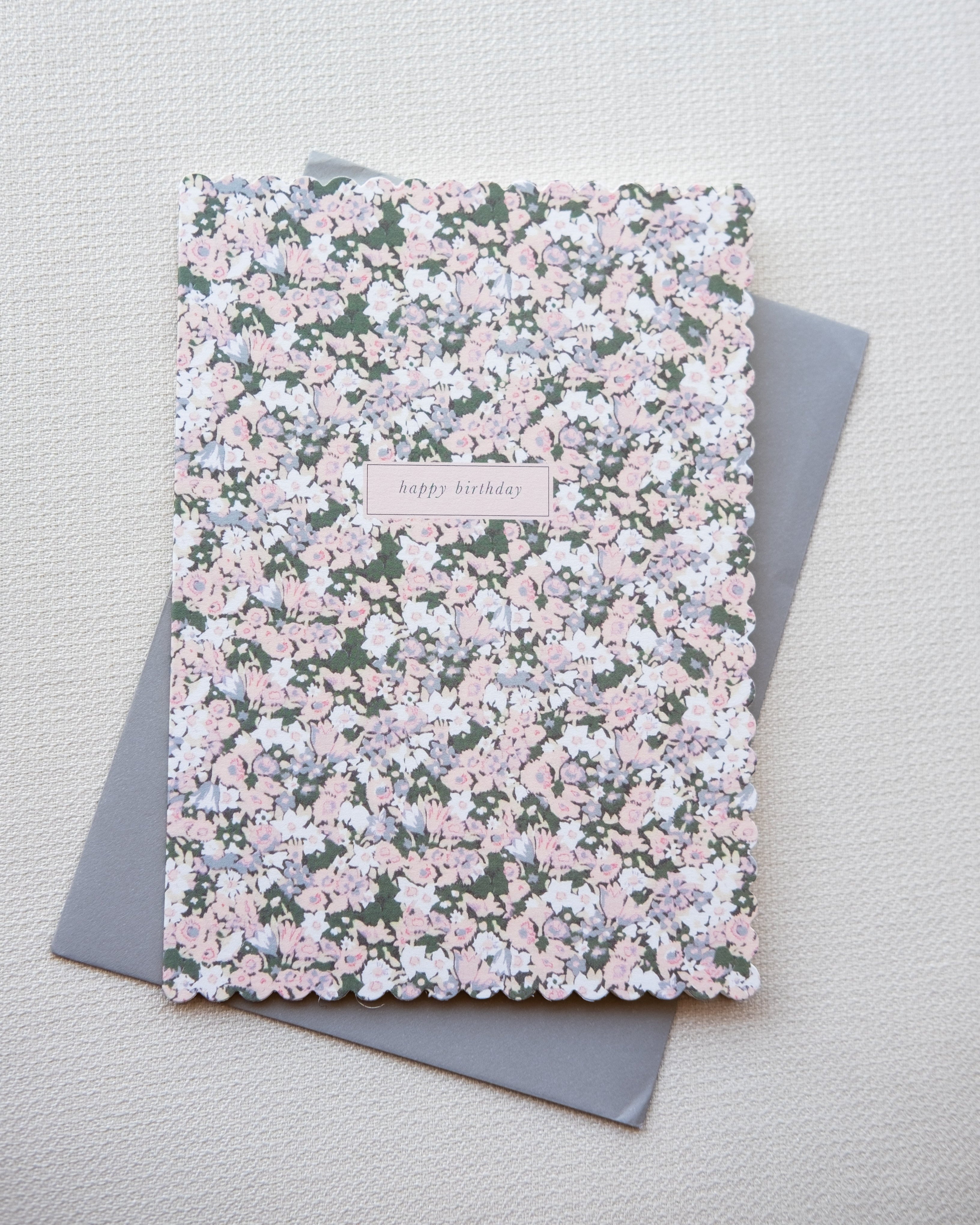 Floral birthday card with a gray cover on a light gray background